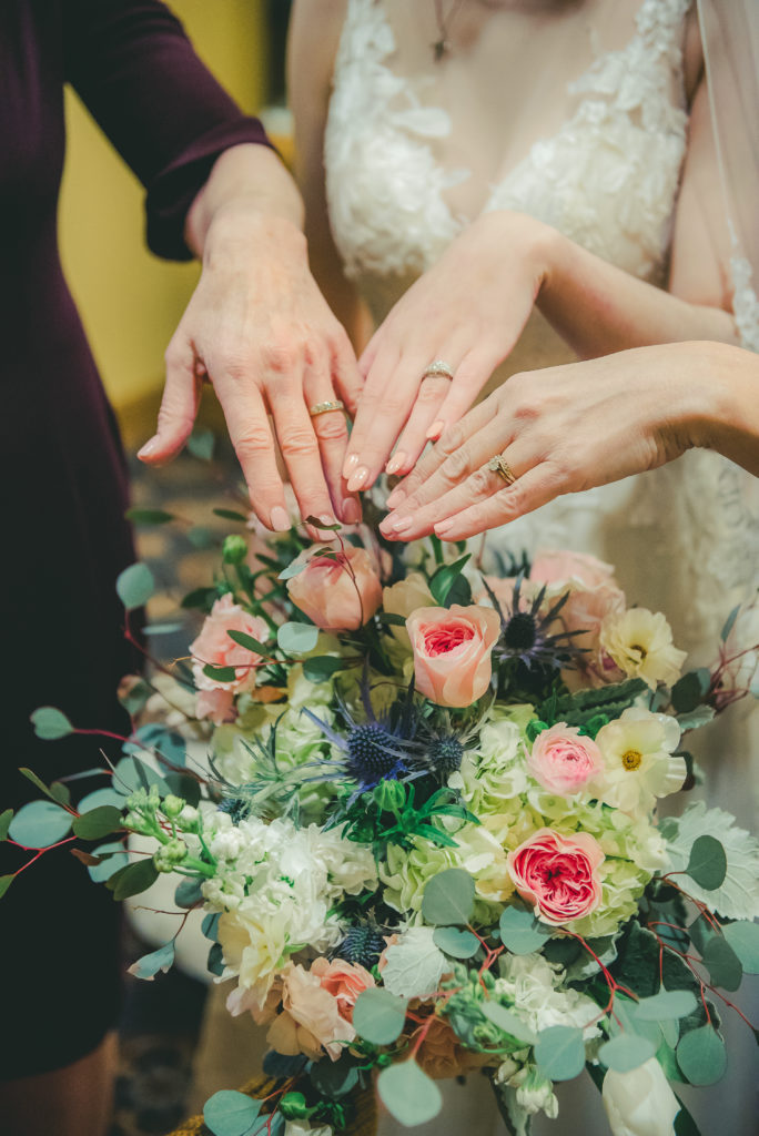 three generations of wedding rings with bouquet