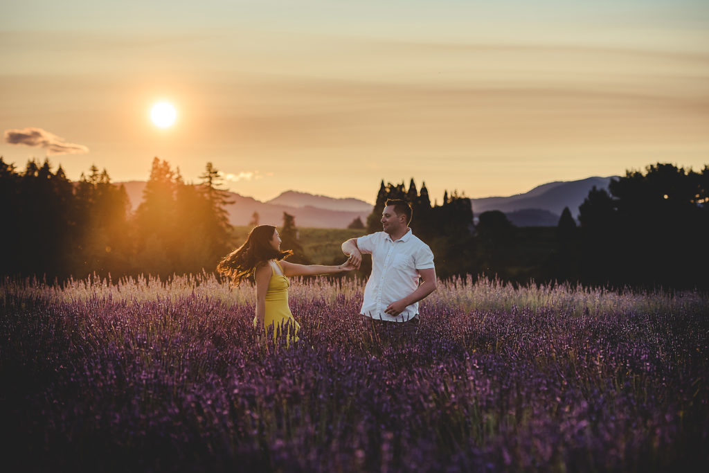 couple dancing in lavender at sunset
