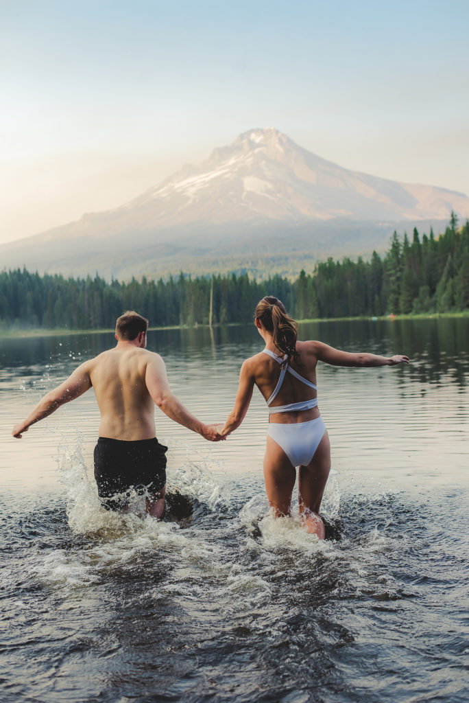 couple jumping into lake
